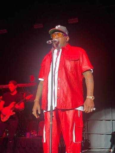 Bobby Brown performing in a red ensemble at the Saban Theatre in Los Angeles.