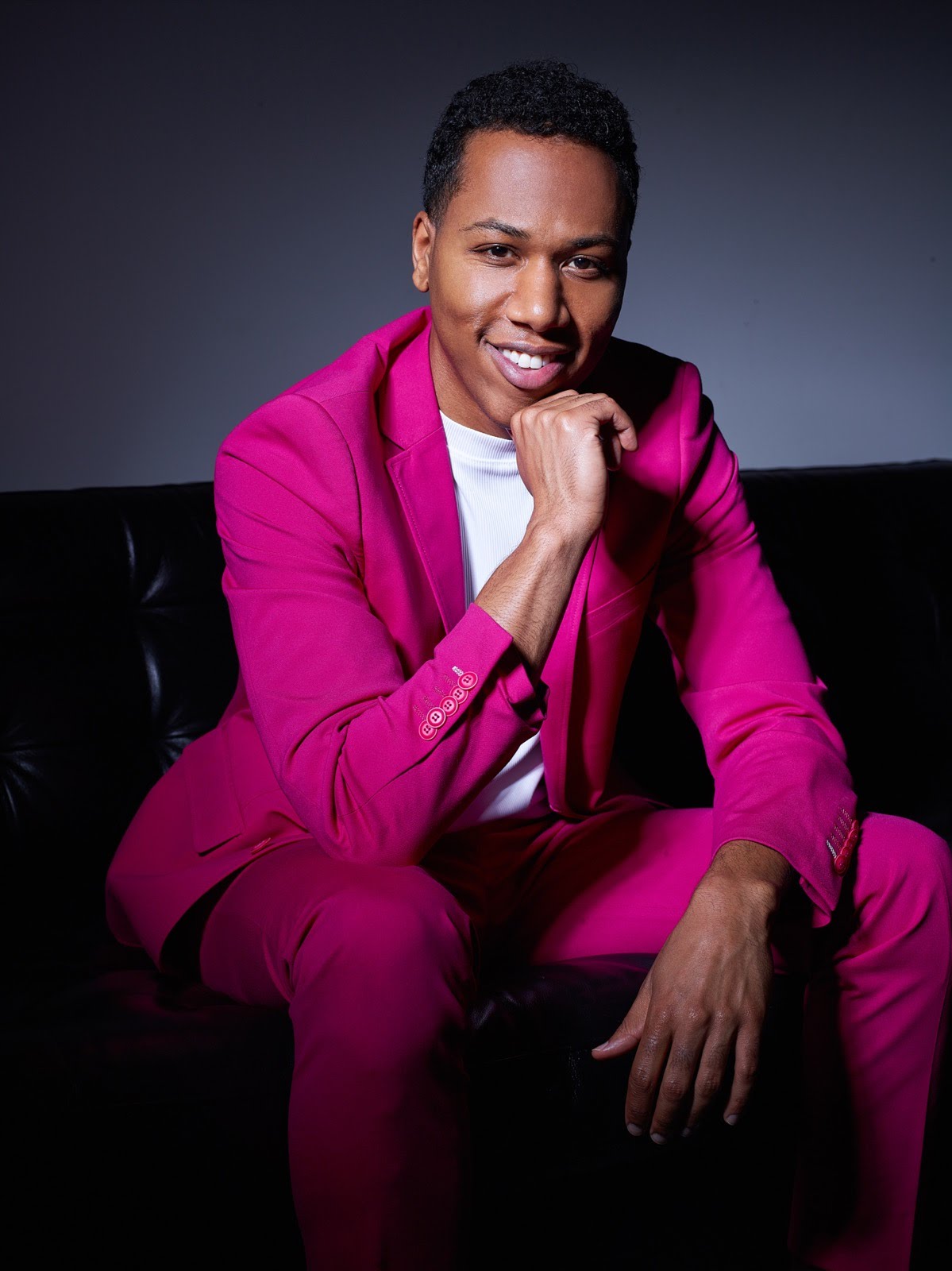 Aaron The Uplifter photographed in a pink suit ahead of the release of his debut single &ldquo;We&rsquo;re Here&rdquo;