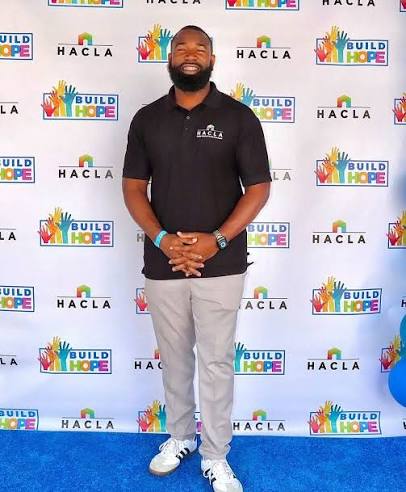Eric "E-Wash" Washington standing at a HACLA "Build Hope" community event.