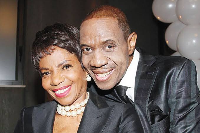 Melba Moore and Freddie Jackson smiling cheek to cheek, she in a pearl necklace and he in a dark suit.