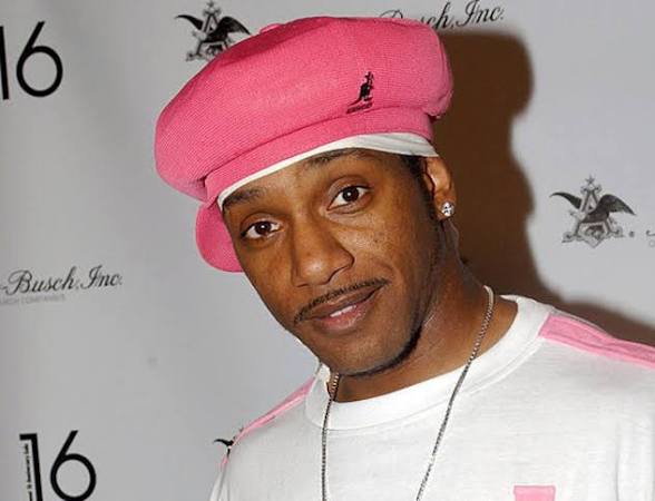 Kangol Kid wearing a pink Kangol cap and matching white and pink shirt at an industry event.