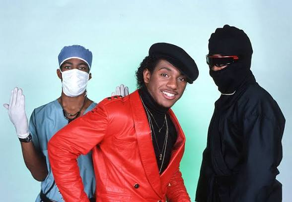 UTFO in the 1980s — Doctor Ice in surgical scrubs, Kangol Kid in a red leather jacket and black Kangol cap, and the Educated Rapper in black.