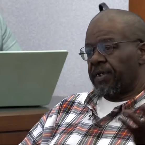 Duane &ldquo;Keffe D&rdquo; Davis, wearing glasses and a plaid shirt, speaking while seated in a courtroom.