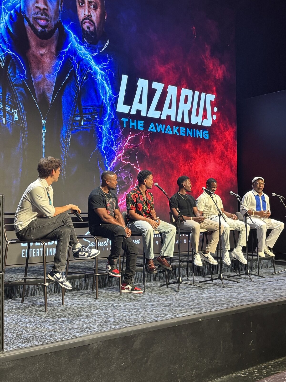 The Lazarus: The Awakening team seated onstage for a moderated panel in front of the film&rsquo;s key art.