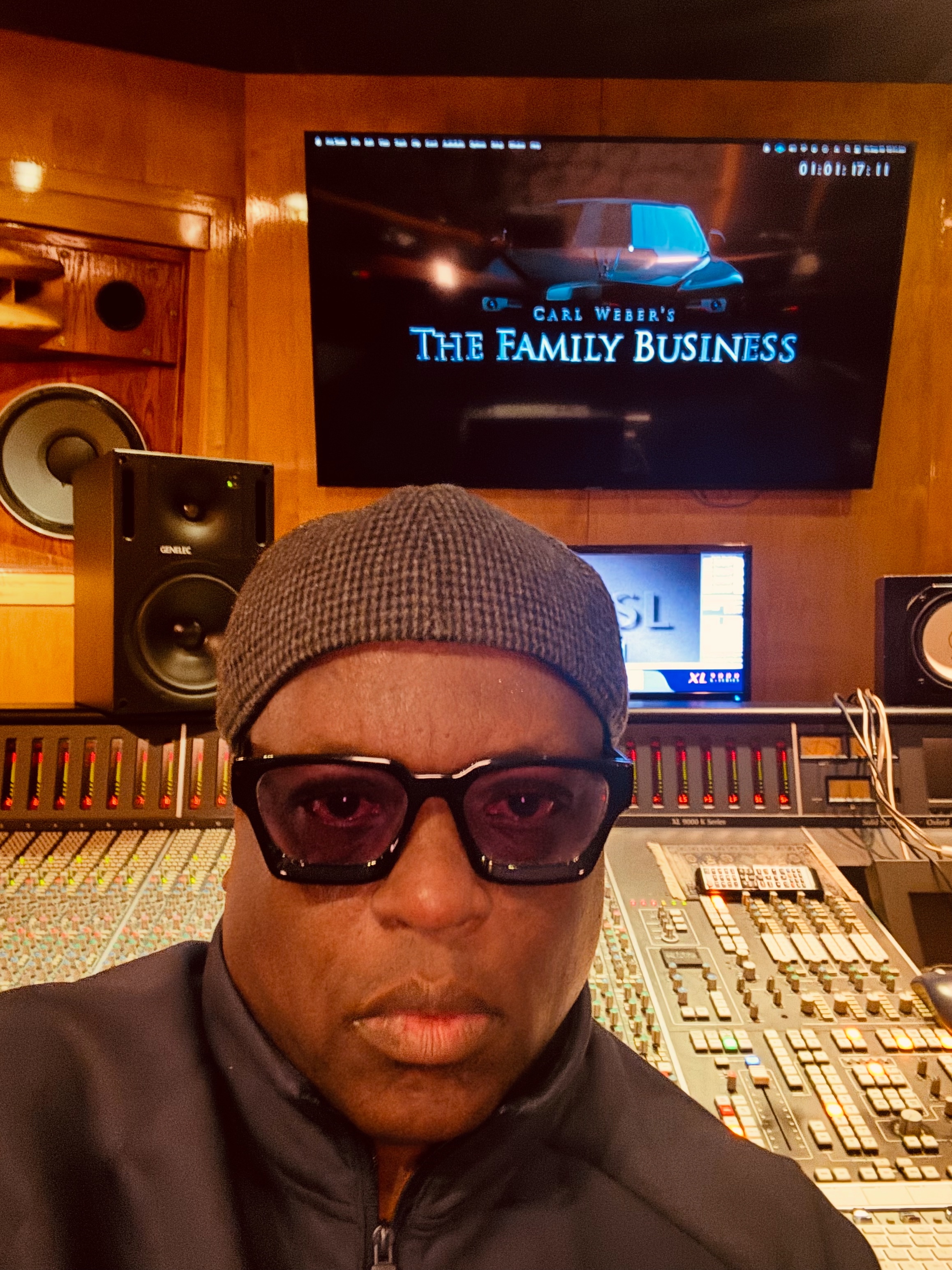 Rob &ldquo;Diggy&rdquo; Morrison at a mixing console with Carl Weber&rsquo;s The Family Business on screen.